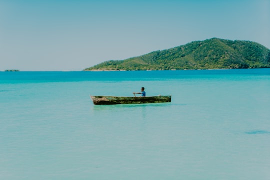 brown wooden dock on body of water during daytime in Cayos Cochinos Honduras