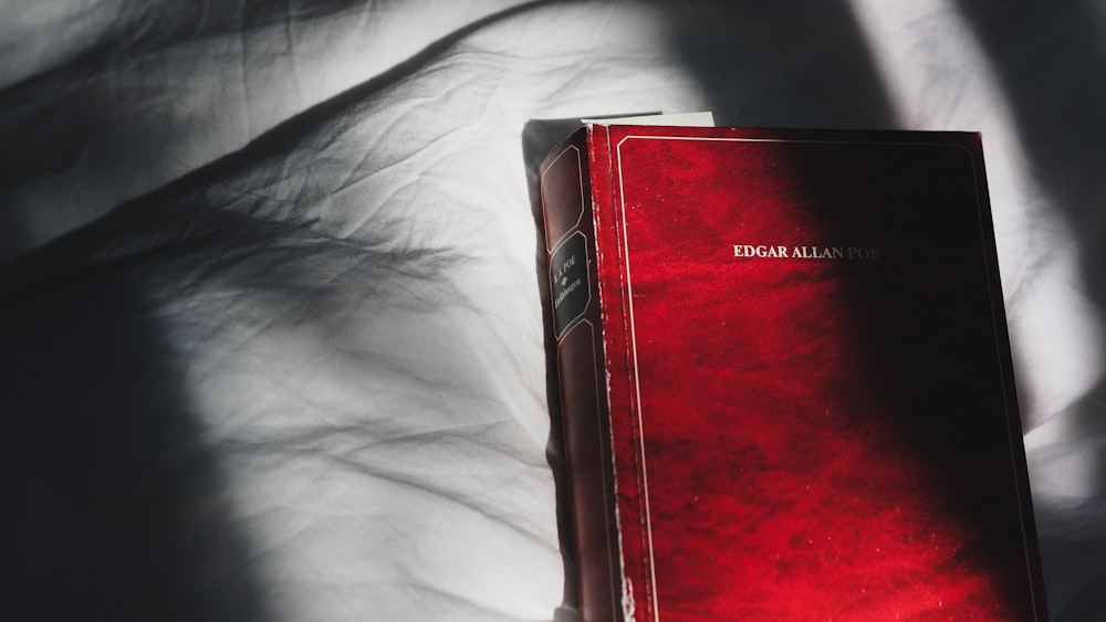 red book on white textile