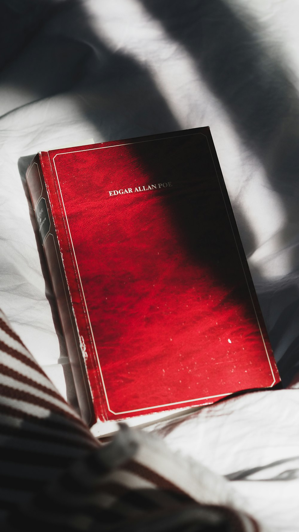 red book on white and black stripe textile