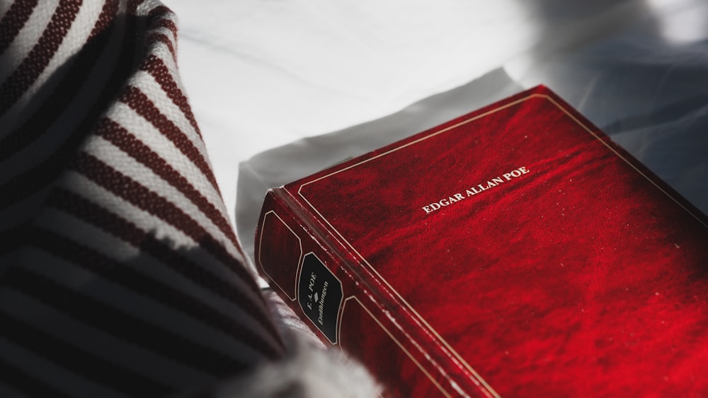 red book on white textile