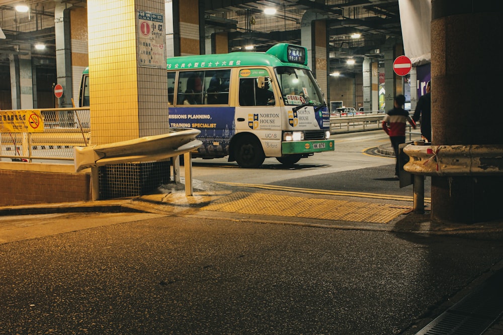 white and green bus on road during daytime