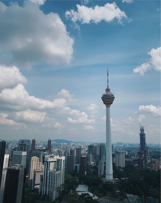 white and black tower under white clouds and blue sky during daytime in Kuala Lumpur Tower Malaysia