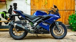 A sleek Yamaha motorcycle displayed with a vibrant blue background highlighting the promo
