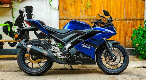 A sleek Yamaha motorcycle displayed with a vibrant blue background highlighting the promo