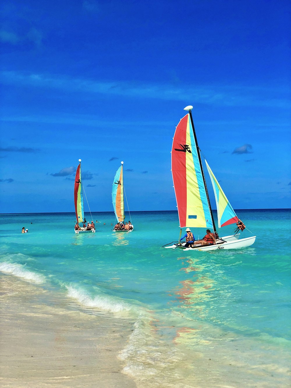 people riding on sail boat on sea during daytime
