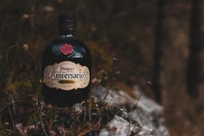 An elegant bottle of wildflower original mead resting on a bed of fresh wildflowers