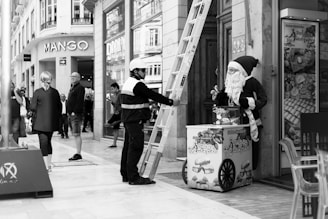 a black and white photo of a man dressed as santa