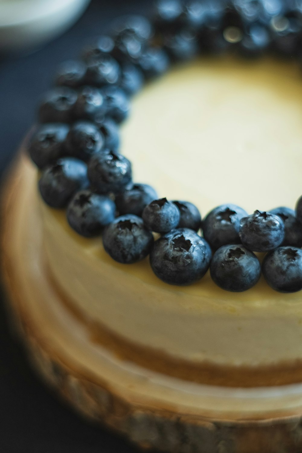 black round fruits on brown wooden round container