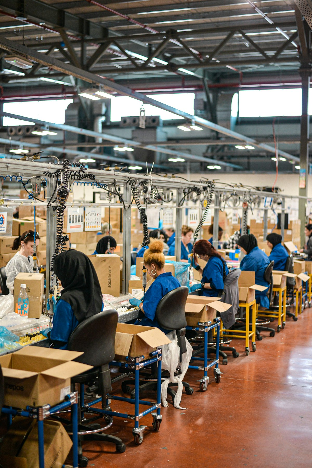 Garment workers sewing apparel on a production line