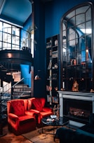 Spacious living room with elegant black, gold, and blue decor.