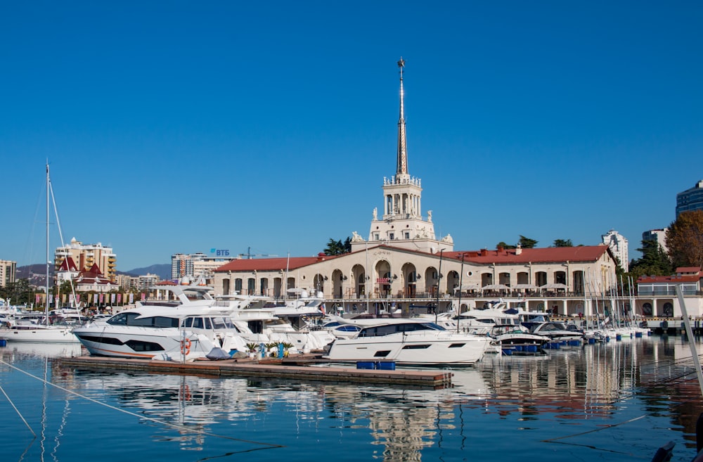 bateau blanc et brun sur l’eau près d’un bâtiment en béton blanc et brun pendant la journée