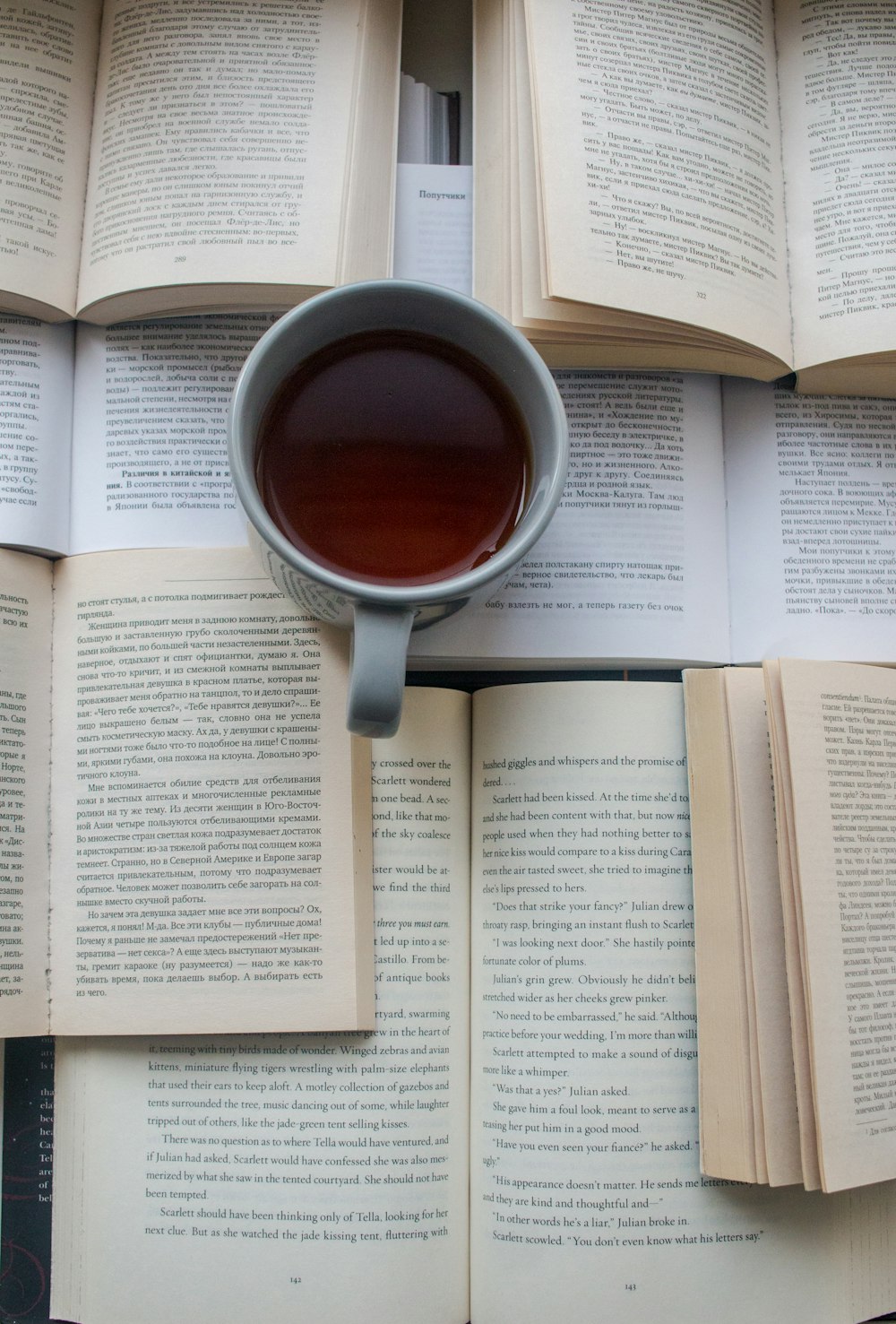 red ceramic mug on book page