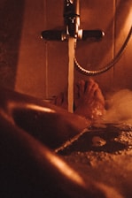 A warm bathroom scene showing a newly installed water heater with visible pipes.