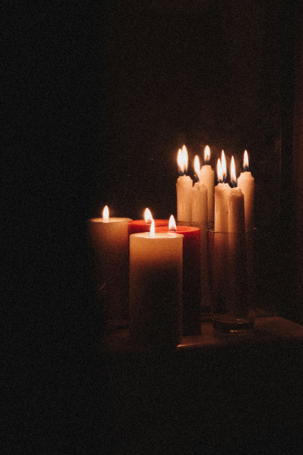 white candles on black background