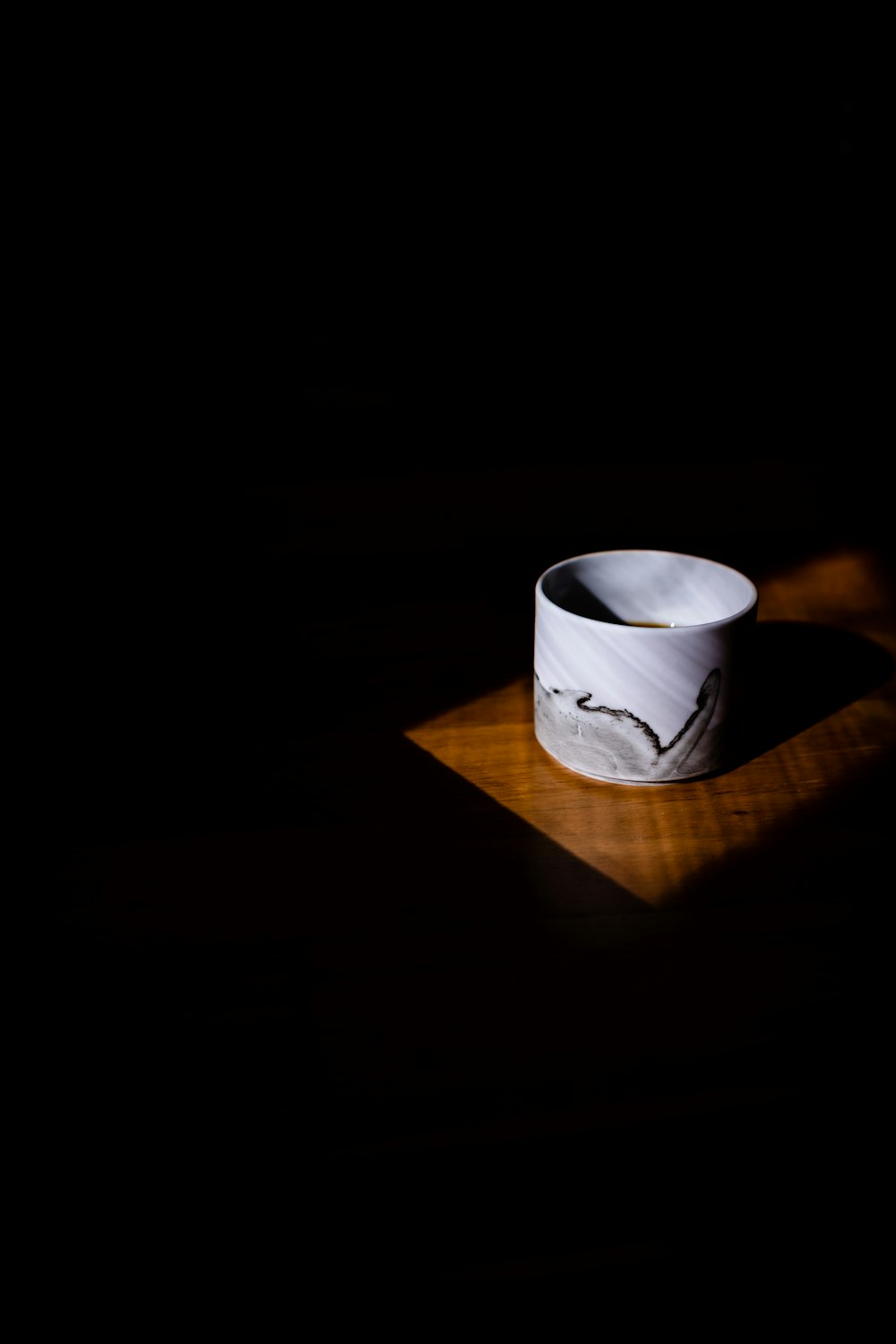 white ceramic mug on brown wooden table