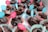 A collection of chocolate muffins is arranged in colorful, patterned paper liners. Each muffin is topped with a small flag displaying the message 'Sweet feelings for you.' The flags are pink and blue, creating a cheerful and inviting presentation.