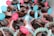 A collection of chocolate muffins is arranged in colorful, patterned paper liners. Each muffin is topped with a small flag displaying the message 'Sweet feelings for you.' The flags are pink and blue, creating a cheerful and inviting presentation.