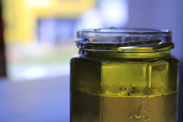 Close-up of vibrant organic sea moss gel in a clear jar, glowing with natural colors.