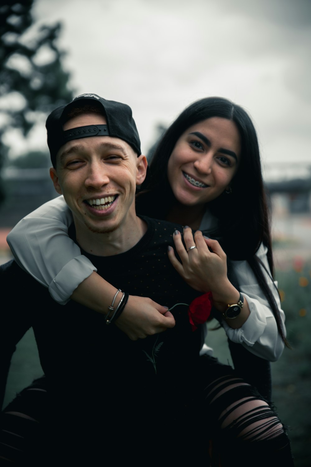 man in black long sleeve shirt smiling beside woman in white long sleeve shirt