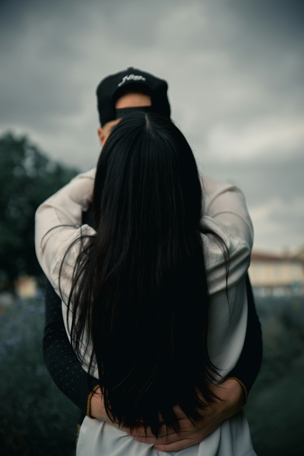 woman in white leather jacket and black knit cap