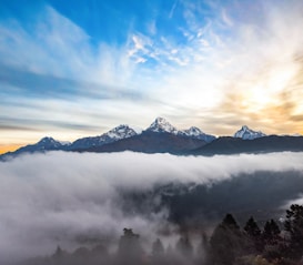 snow covered mountain under cloudy sky during daytime