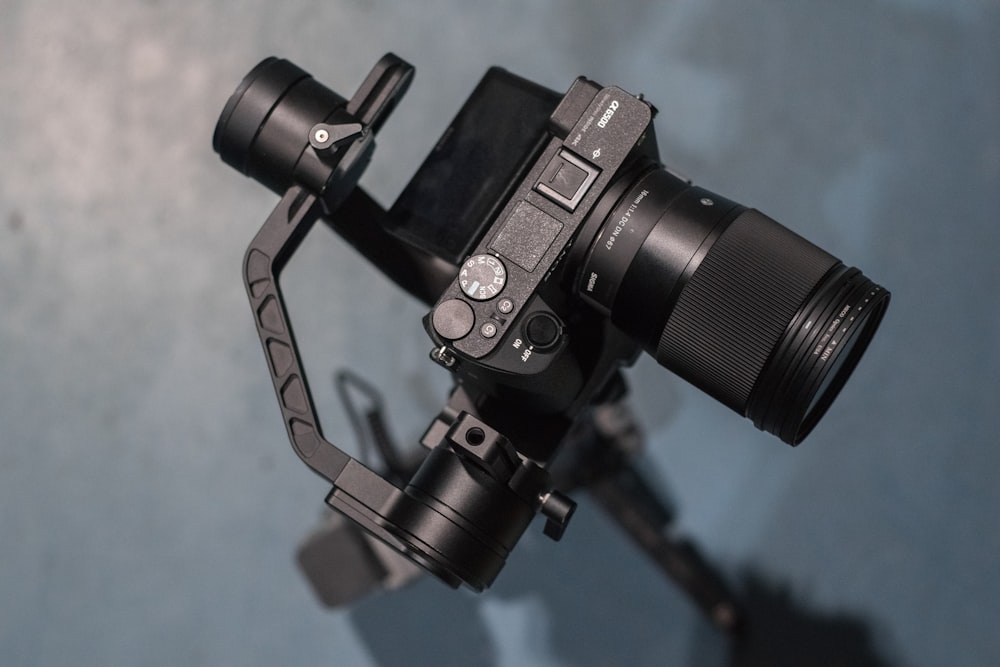 black dslr camera on tripod