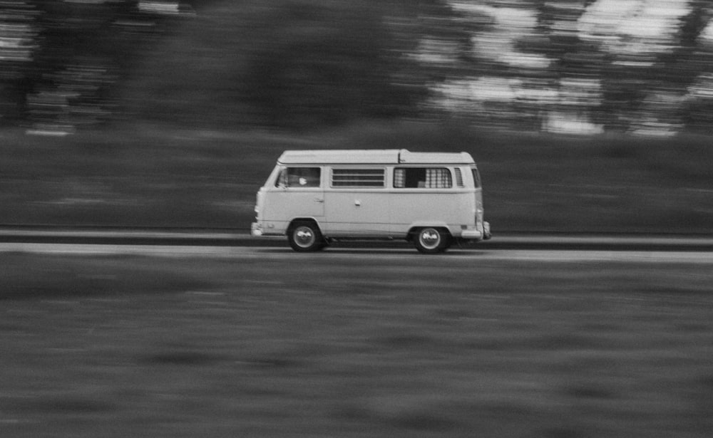 white van on road in grayscale photography