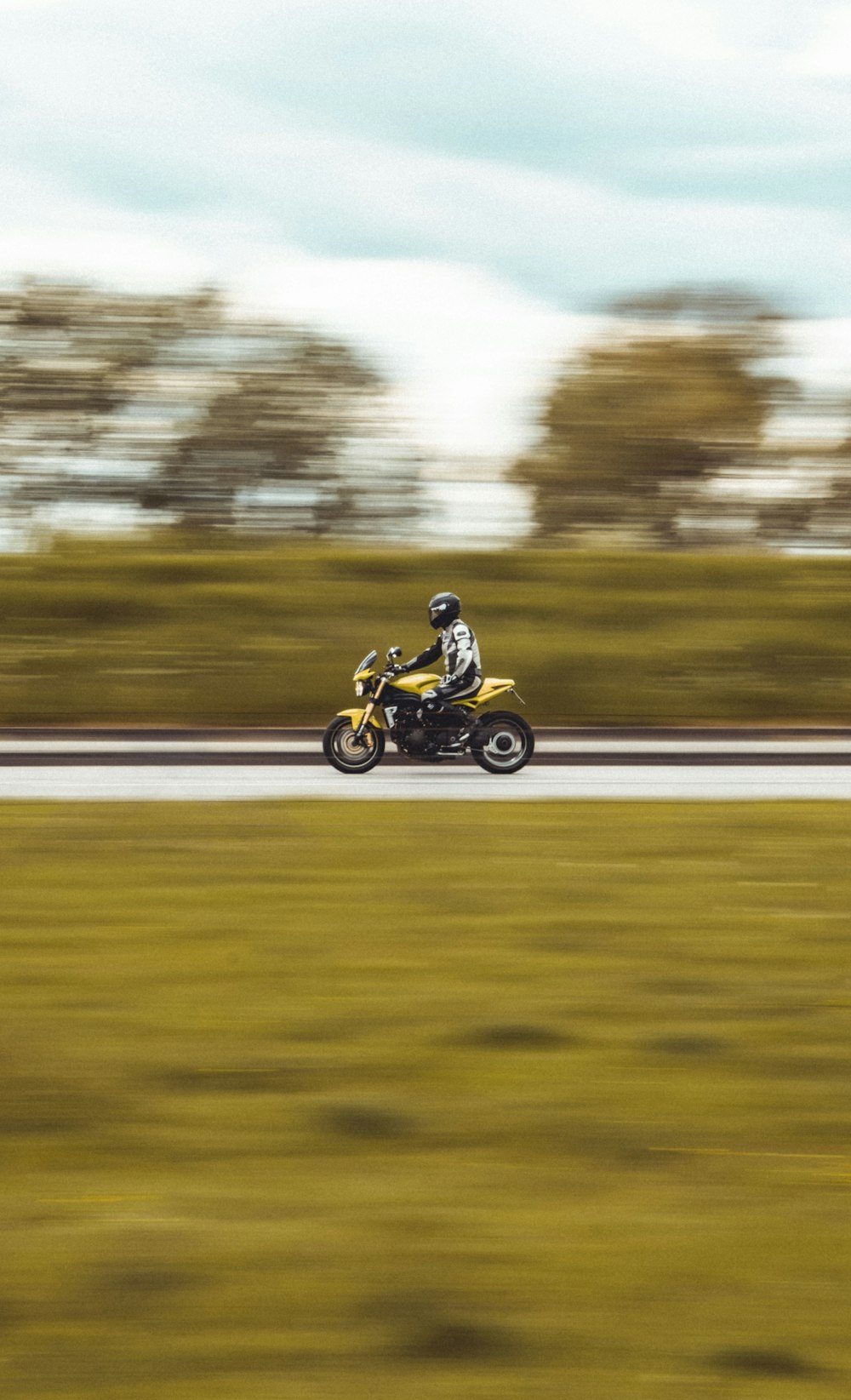 man riding motorcycle on road during daytime