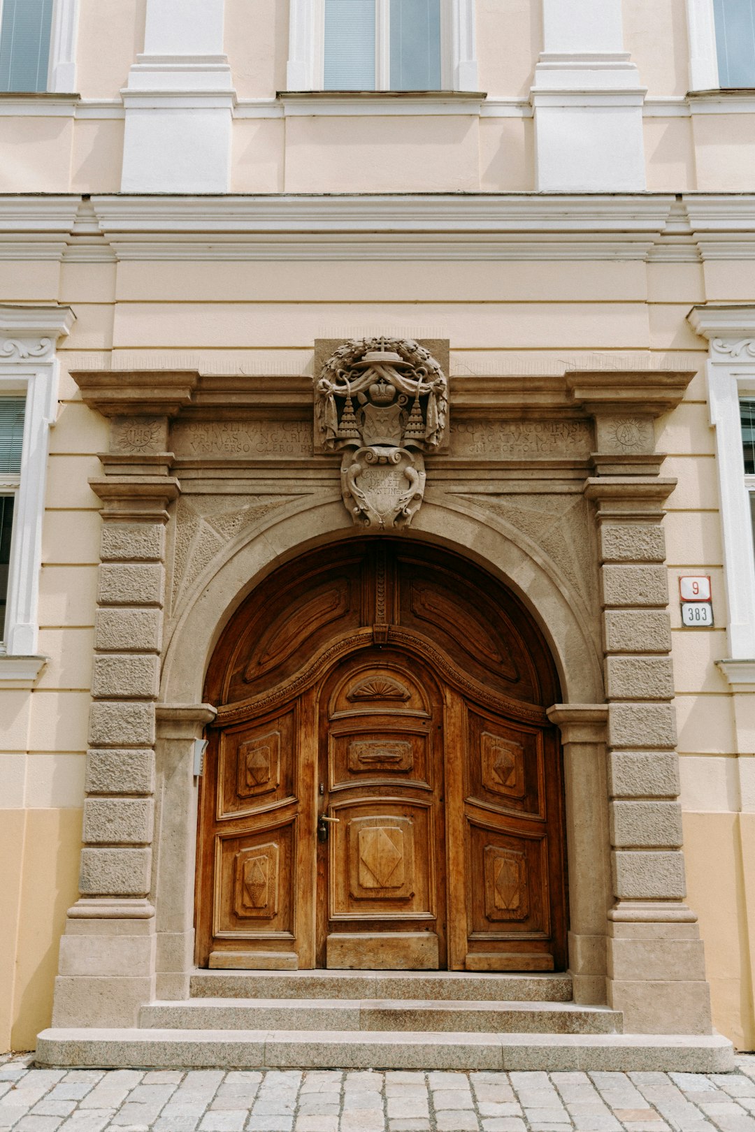 brown wooden door on white concrete building