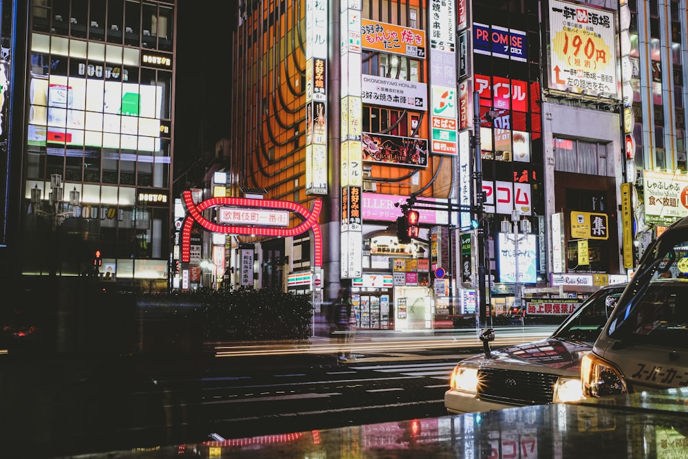 Coches en la carretera cerca de edificios de gran altura durante la noche