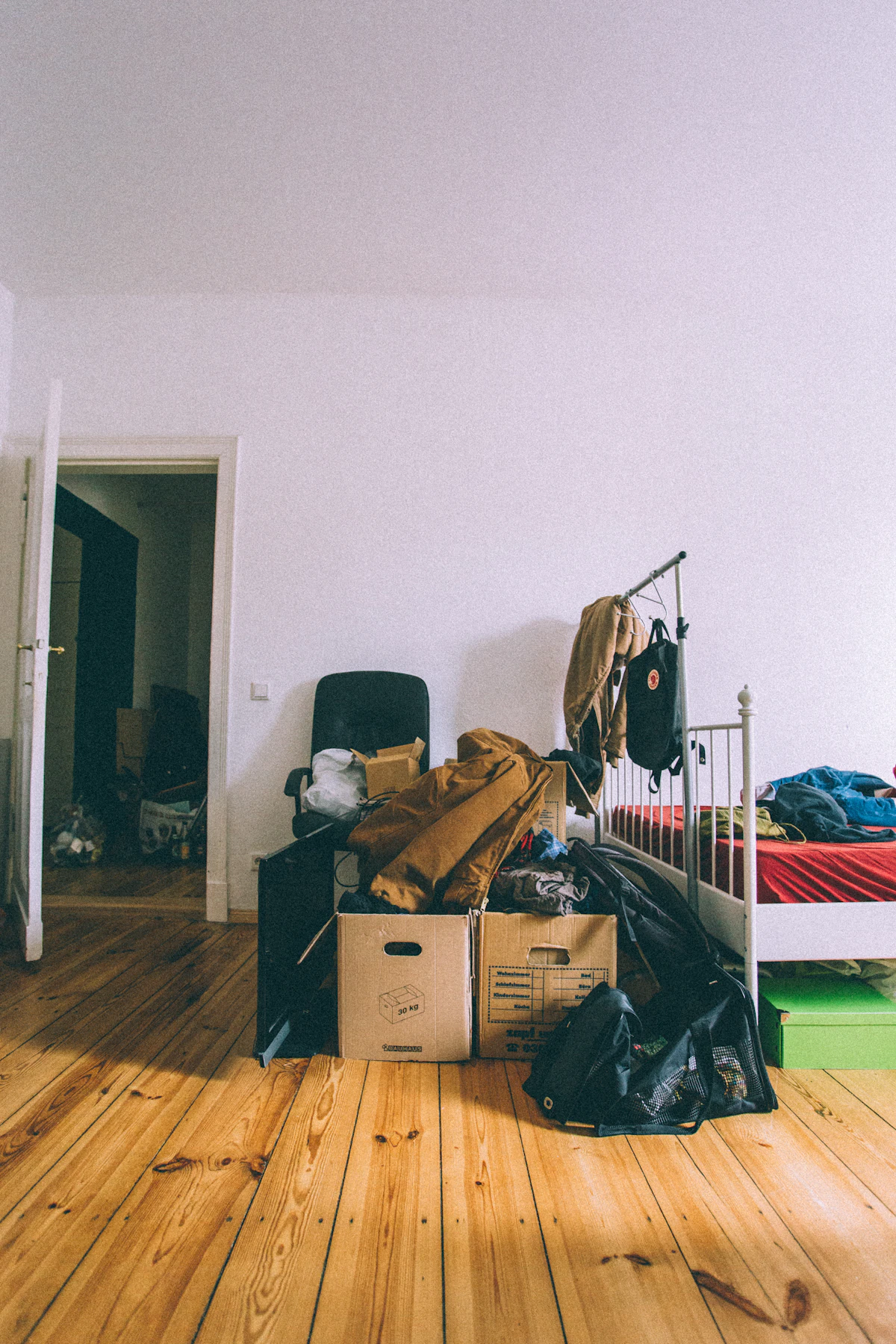 Moving boxes stacked on a hardwood floor