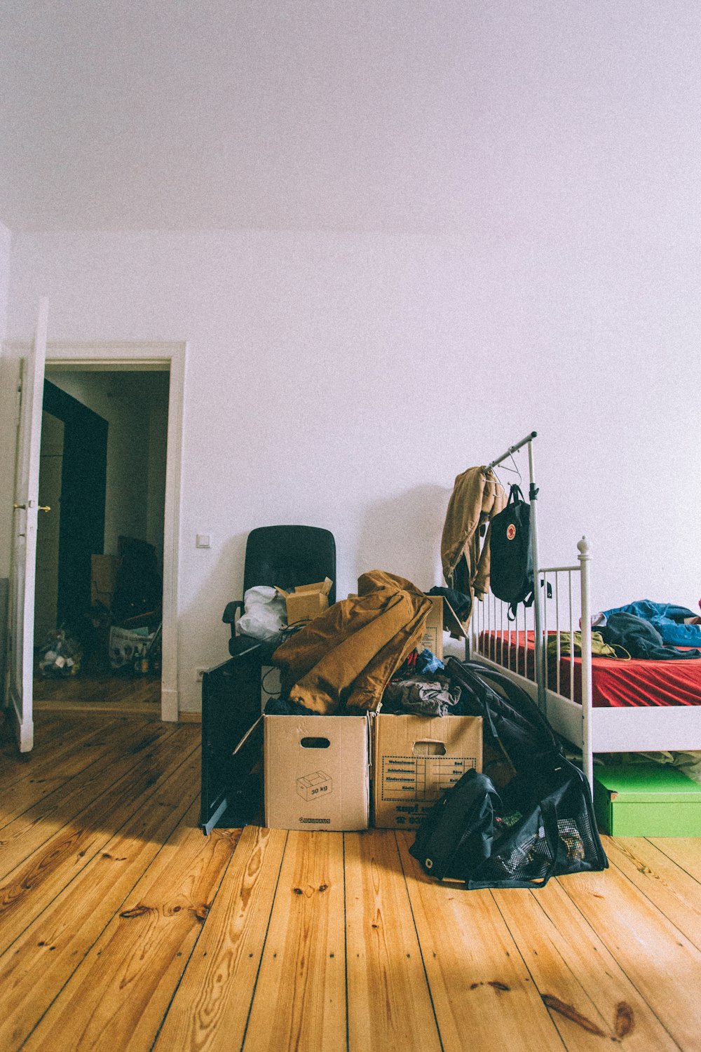 brown cardboard boxes on brown wooden parquet floor