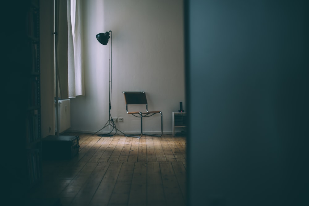 black and white chair beside white wall