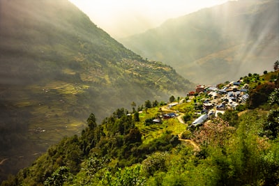 green mountain near body of water during daytime nepal teams background