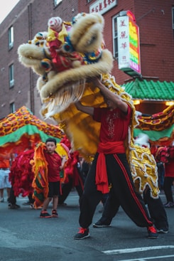 people in red and brown traditional dress walking on street during daytime