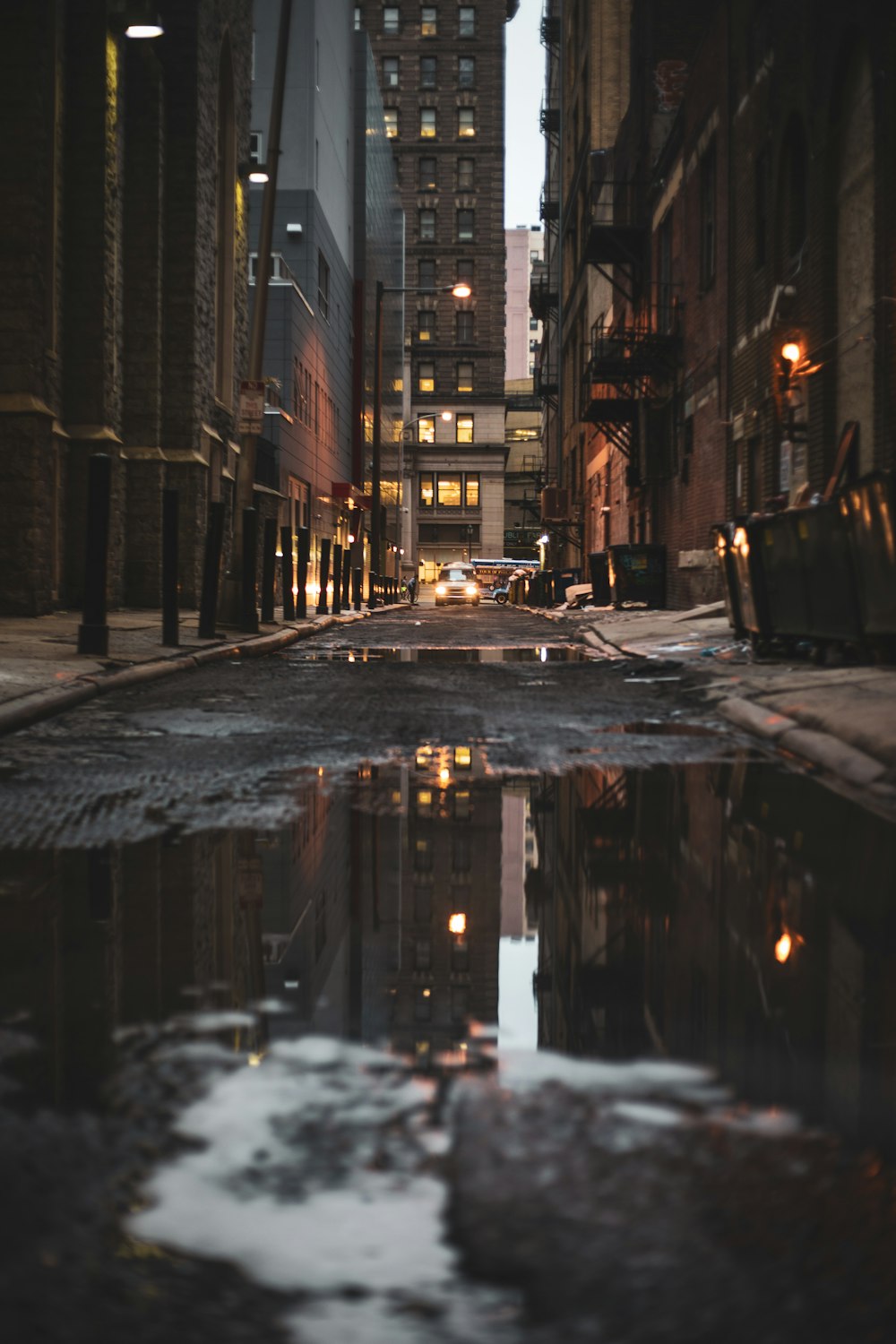 a city street with puddles of water on the ground