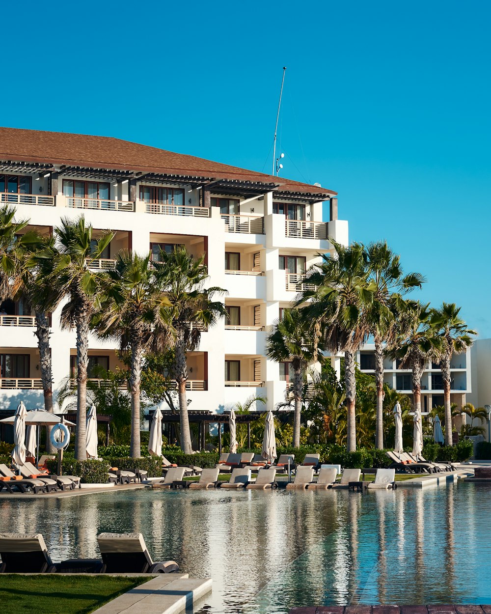 white and brown concrete building near body of water during daytime