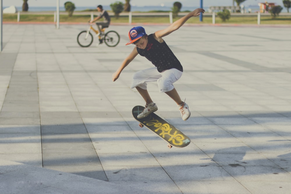 man in blue t-shirt and white shorts riding on skateboard during daytime