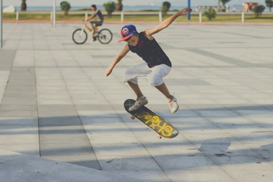 man in blue t-shirt and white shorts riding on skateboard during daytime in Batumi Bay Georgia