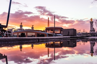 A vibrant sunset casting golden light over the Eiffel Tower in Paris.