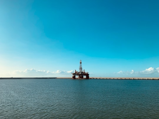 red and white ship on sea under blue sky during daytime in São João da Barra Brasil