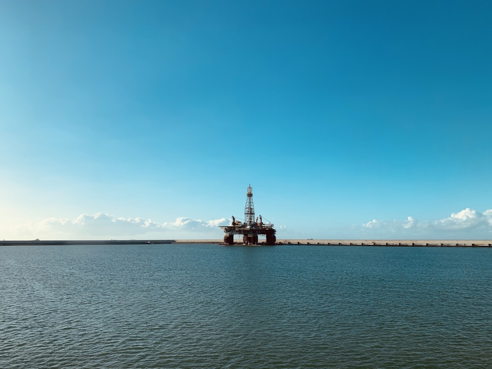 red and white ship on sea under blue sky during daytime