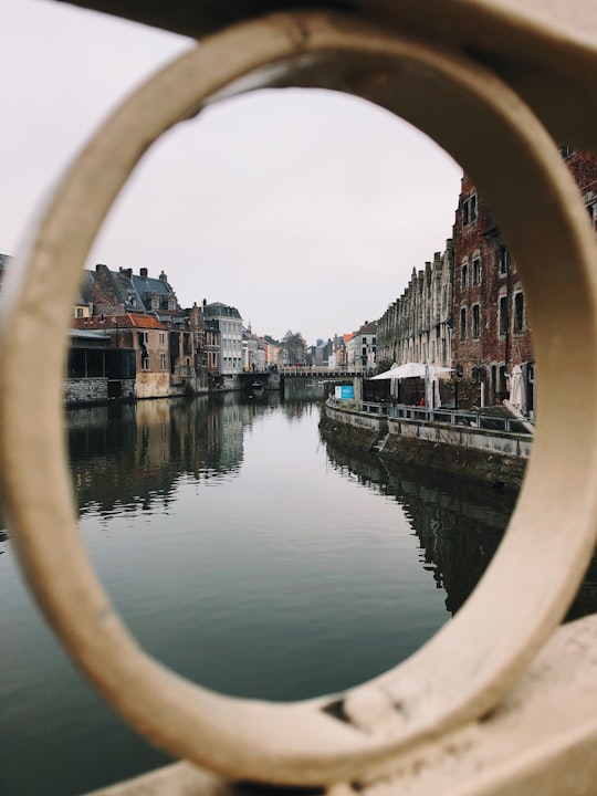 body of water between buildings during daytime in Korenmarkt Belgium