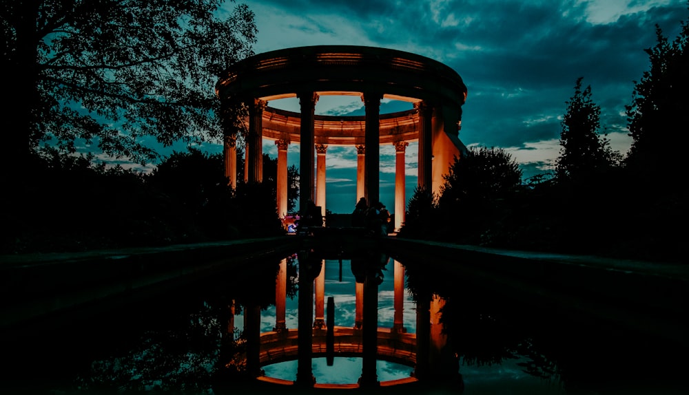 brown gazebo near green trees during daytime