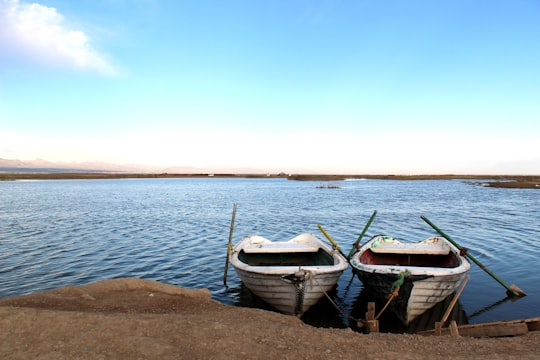 blue and white boat on shore during daytime in Abyek Iran