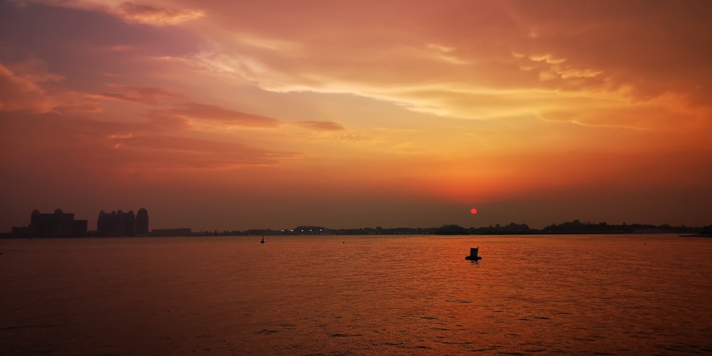 silhouette of 2 people on beach during sunset