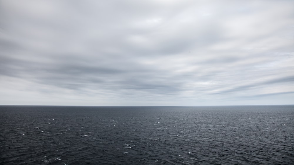 body of water under cloudy sky during daytime