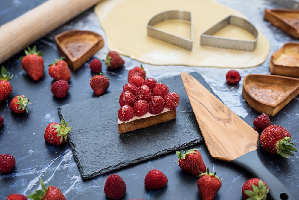 strawberries on brown wooden chopping board