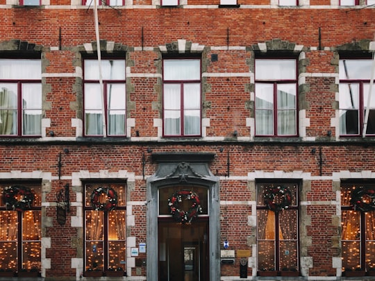 brown brick building with glass windows in Brugge Belgium