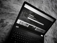 The hello world website homepage displayed on a sleek laptop screen.